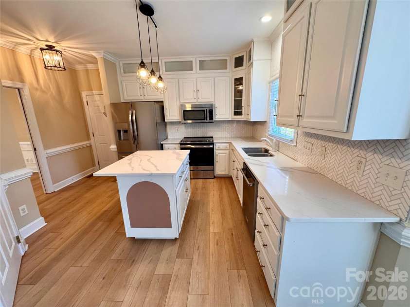 7101 Founders Way, Harris, NC 28075.  MLS# CAR4435546, YatesRealty ID 57347. Renovated kitchen with quartz countertops and marble tile backsplash. Stainless appliances convey.