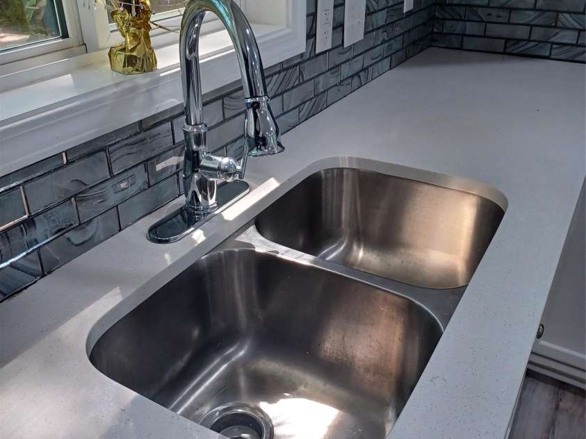 5717 Ruth Drive, Charlotte, NC 28215.  MLS# CAR4435760, YatesRealty ID 57388. Beautifully updated kitche sink, faucet, and countertops with Glass backspash