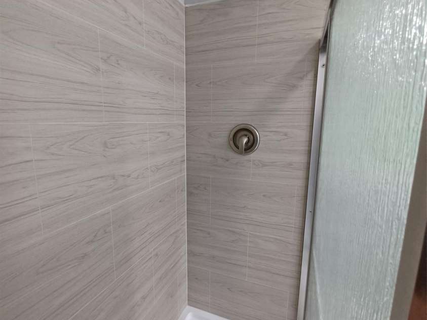 5717 Ruth Drive, Charlotte, NC 28215.  MLS# CAR4435760, YatesRealty ID 57388. Primary Bath shower with all new finishes