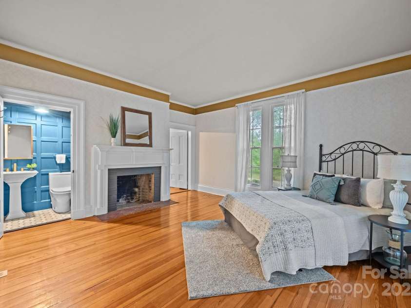 740 Woodlawn Avenue, Mount Holly, NC 28120.  MLS# CAR4244621, YatesRealty ID 5739. Main floor bedroom with fireplace and modern half bath