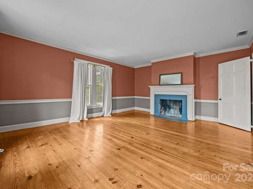 740 Woodlawn Avenue, Mount Holly, NC 28120.  MLS# CAR4244621, YatesRealty ID 5739. Secondary bedroom with fireplace and pine floors