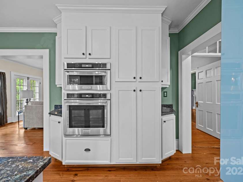 740 Woodlawn Avenue, Mount Holly, NC 28120.  MLS# CAR4244621, YatesRealty ID 5739. The kitchen features a Wolf electric cooktop, Miele dishwasher, and Kitchen-Aid wall oven and microwave.