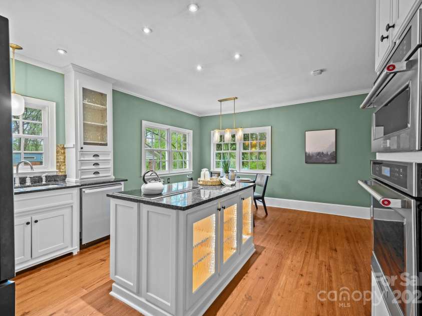740 Woodlawn Avenue, Mount Holly, NC 28120.  MLS# CAR4244621, YatesRealty ID 5739. The kitchen features a Wolf electric cooktop, Miele dishwasher, and Kitchen-Aid wall oven and microwave.