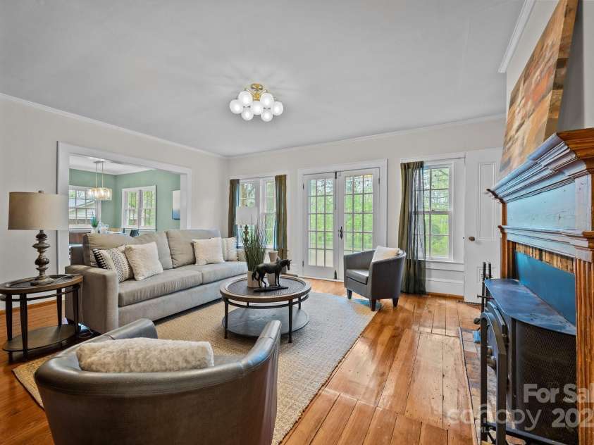 740 Woodlawn Avenue, Mount Holly, NC 28120.  MLS# CAR4244621, YatesRealty ID 5739. This is the family room and is just off of the kitchen.  The french doors lead out to the side patio on the right hand side of the house.  There is a working woodstove in this room as well as a wall of built in booksh