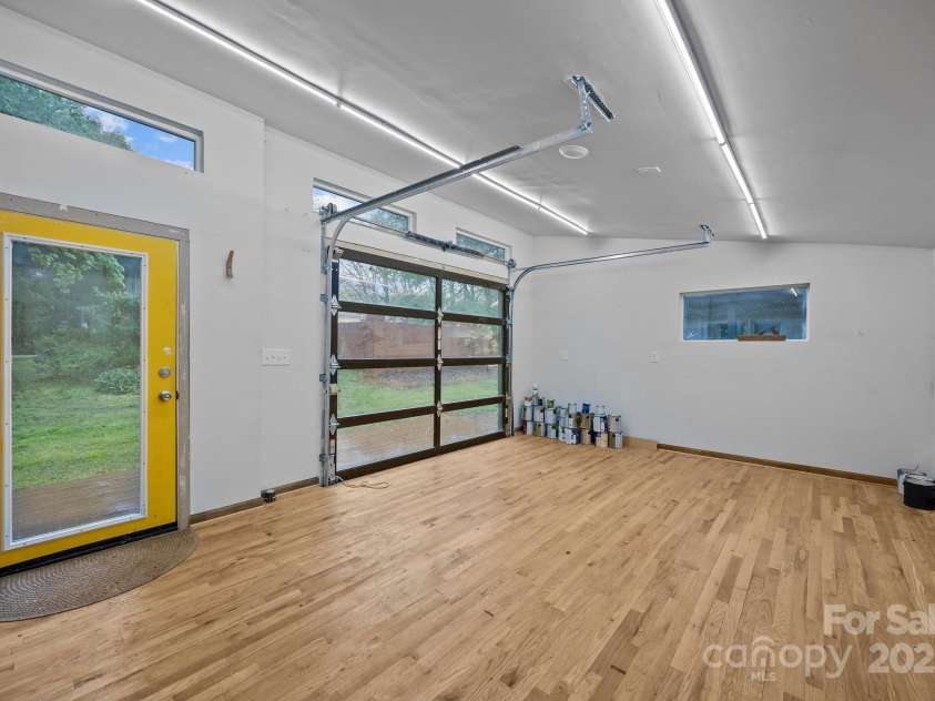 740 Woodlawn Avenue, Mount Holly, NC 28120.  MLS# CAR4244621, YatesRealty ID 5739. This is the interior of the modern outbuilding.  It would make a great art studio or workshop! It's over 200 sq. ft. (about the size of a one car garage).The modern outbuilding and attached deck do not convey with the