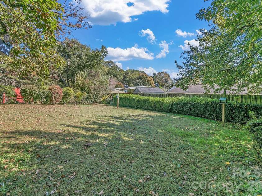 1 Dewberry Lane, Hendersonville, NC 28792.  MLS# CAR4435645, YatesRealty ID 57487. Back yard view from sunroom