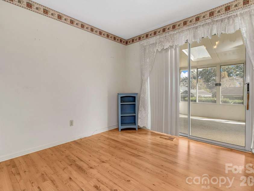 1 Dewberry Lane, Hendersonville, NC 28792.  MLS# CAR4435645, YatesRealty ID 57487. Dining area w/sunroom access