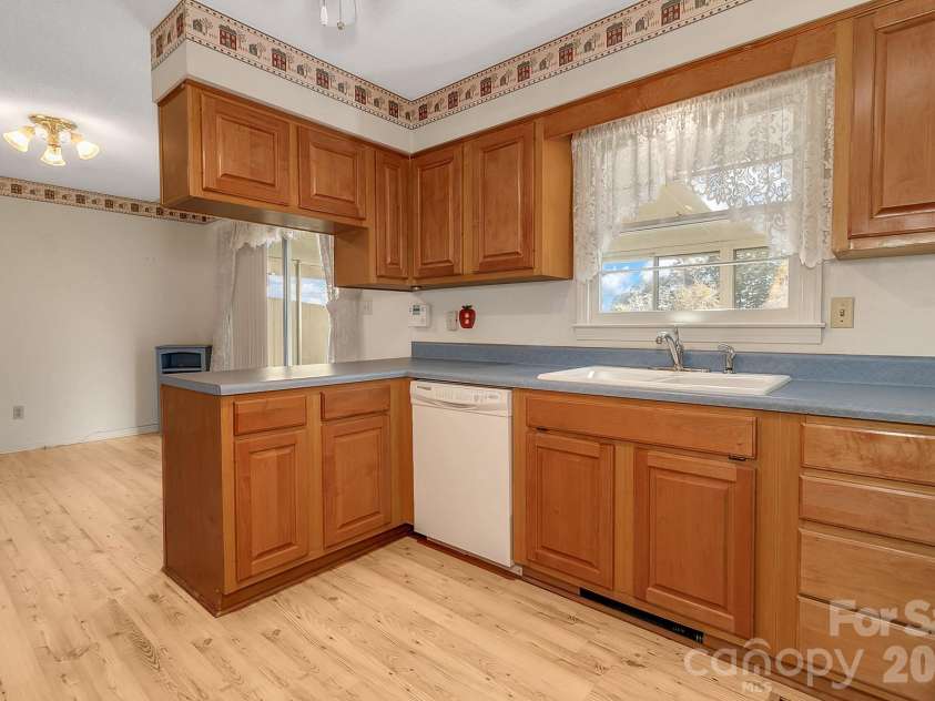 1 Dewberry Lane, Hendersonville, NC 28792.  MLS# CAR4435645, YatesRealty ID 57487. Kitchen w/window over sink & looking into dining area