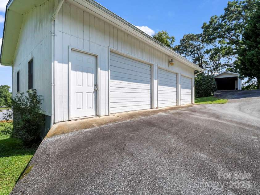 256 School Road, Mill Spring, NC 28756.  MLS# CAR4299323, YatesRealty ID 5755. 3-Car garage with yard door, windows & electric