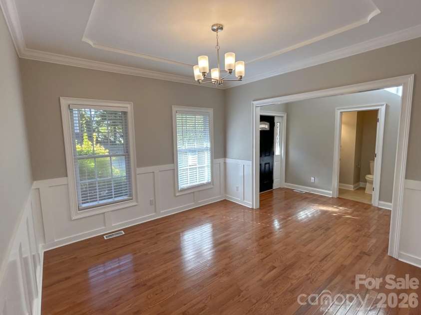 201 Colonel Holcombe Place, Candler, NC 28715.  MLS# CAR4436091, YatesRealty ID 57568. Dining Room with tray ceiling and wainscoting