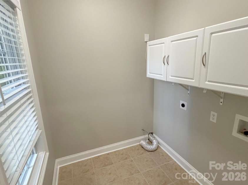 201 Colonel Holcombe Place, Candler, NC 28715.  MLS# CAR4436091, YatesRealty ID 57568. Laundry room on main level off kitchen