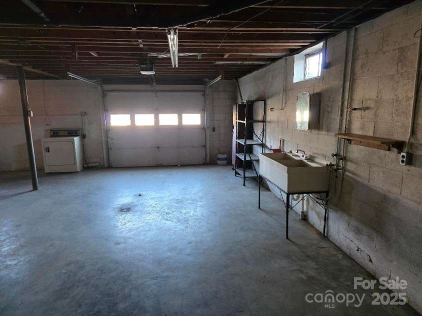 1375 US Highway 19E Highway, Burnsville, NC 28714.  MLS# CAR4329254, YatesRealty ID 576. Garage door and drive in basement