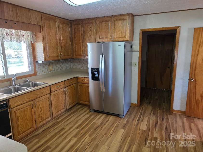 1375 US Highway 19E Highway, Burnsville, NC 28714.  MLS# CAR4329254, YatesRealty ID 576. Kitchen with recently purchased refrigerator