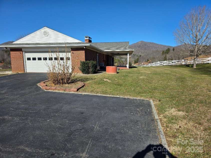 1375 US Highway 19E Highway, Burnsville, NC 28714.  MLS# CAR4329254, YatesRealty ID 576. South view of house including parking area and 2-car garage