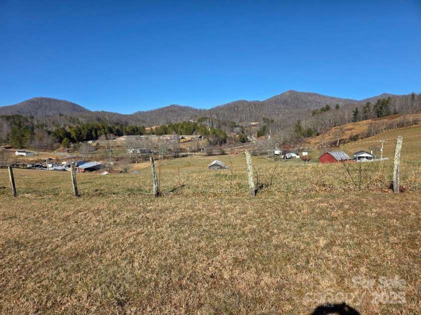 1375 US Highway 19E Highway, Burnsville, NC 28714.  MLS# CAR4329254, YatesRealty ID 576. View looking north with Burnsville Elementary School in the foreground and King's Mountain/Sol Fox Knob in the background