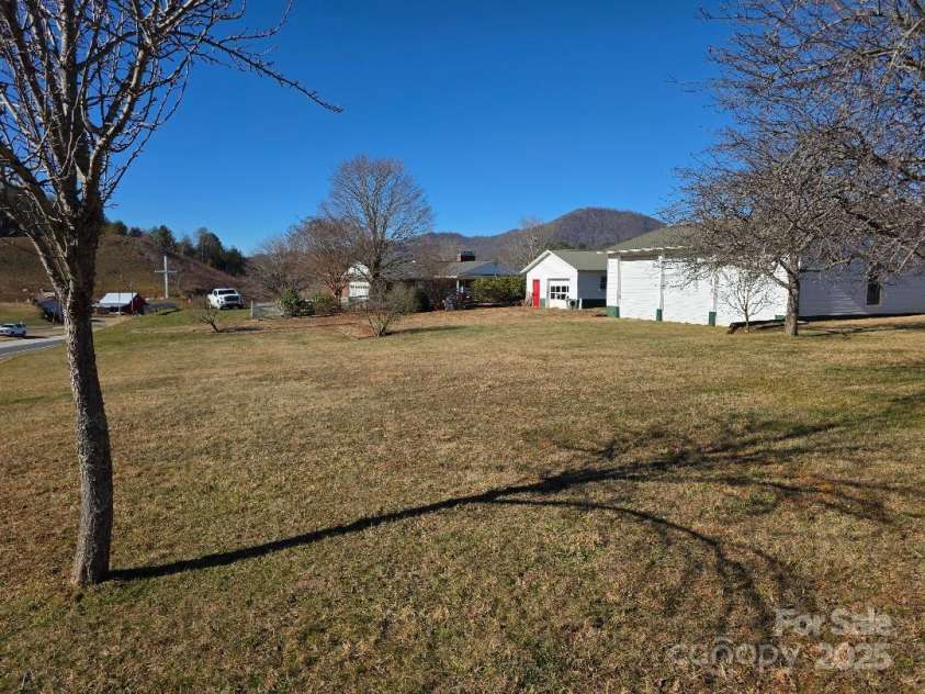 1375 US Highway 19E Highway, Burnsville, NC 28714.  MLS# CAR4329254, YatesRealty ID 576. View of large rear lawn, detached garages and rear of house