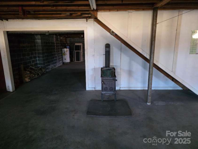 1375 US Highway 19E Highway, Burnsville, NC 28714.  MLS# CAR4329254, YatesRealty ID 576. Wood stove in basement