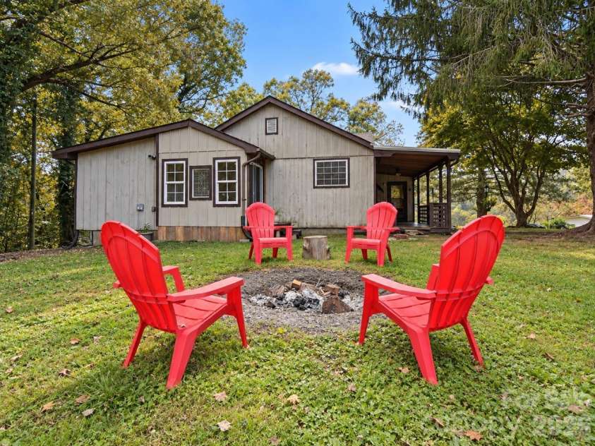 62 Hughey Drive, Mills River, NC 28759.  MLS# CAR4436207, YatesRealty ID 57671. Side of House and Fire Pit