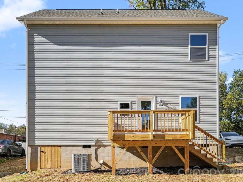 125 Buffalo Avenue, Concord, NC 28025.  MLS# CAR4436438, YatesRealty ID 57809. Back yard view with wooden deck.
