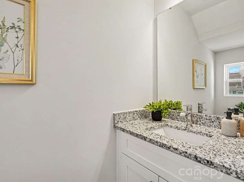 125 Buffalo Avenue, Concord, NC 28025.  MLS# CAR4436438, YatesRealty ID 57809. Half bathroom on main level hallway has a single vanity and granite countertop for a nice touch. This photo is a representation of home taken from identical home next door. Actual photos are in process.