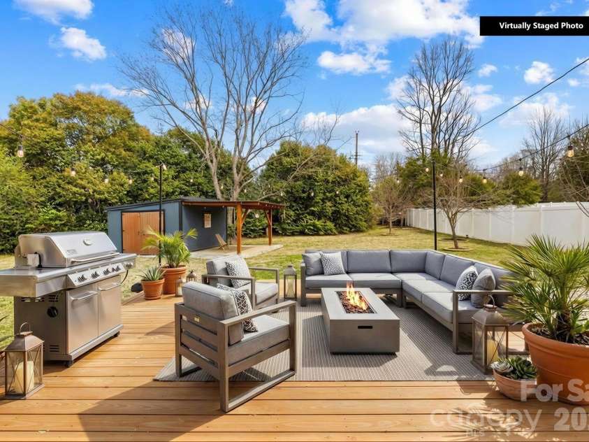 4127 Strangford Avenue, Charlotte, NC 28215.  MLS# CAR4351273, YatesRealty ID 5791. This image includes virtual staging to show the large back patio’s potential layout and use. Awesome backyard space perfect for so many things!