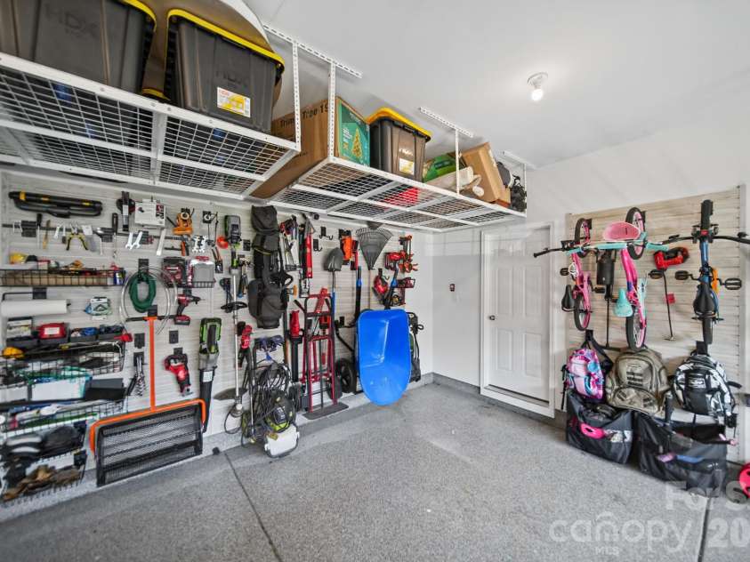 1112 Alyssa Oaks Drive, Lowell, NC 28098.  MLS# CAR4435790, YatesRealty ID 57931. Garage with customizable storage and epoxy floor.