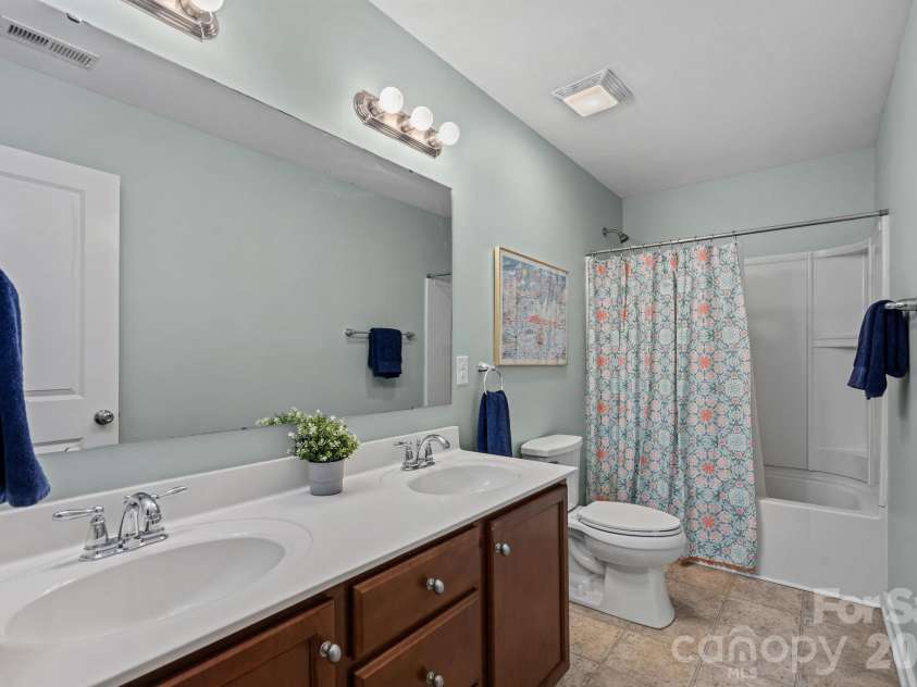 13326 Pierre Reverdy Drive, Davidson, NC 28036.  MLS# CAR4435596, YatesRealty ID 57935. Upstairs shared bathroom has a double vanity