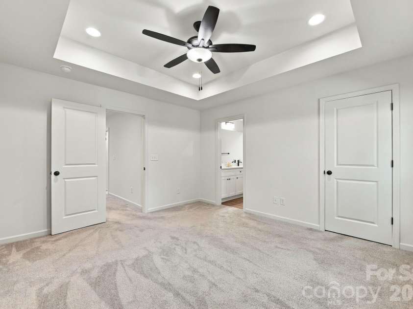 4715 Crestmont Drive, Charlotte, NC 28205.  MLS# CAR4436619, YatesRealty ID 58001. Primary bedroom with tray ceiling overlooks tree-lined yard for privacy