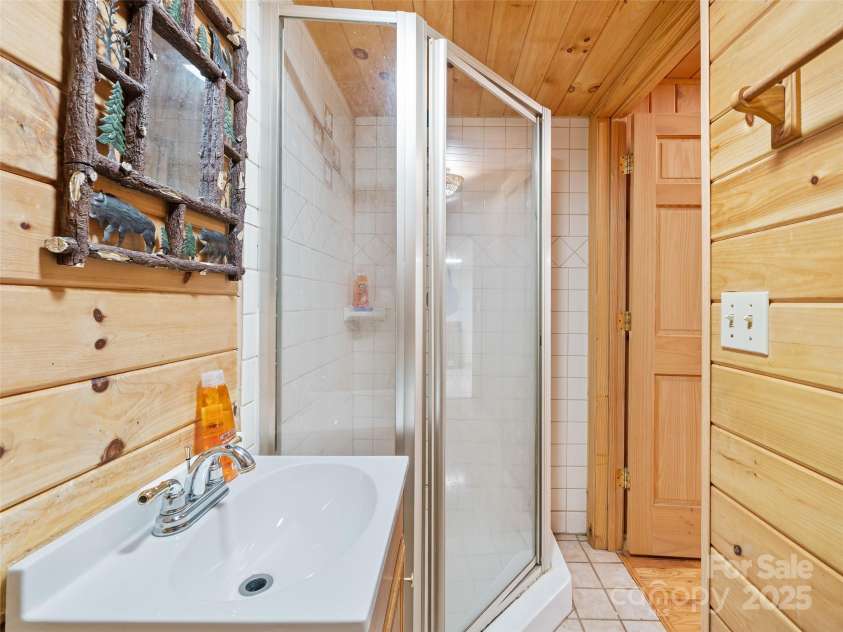 211 Cherry Hollow Road, Burnsville, NC 28714.  MLS# CAR4246541, YatesRealty ID 5803. Downstairs Bathroom