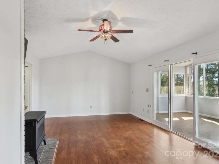 127 Kalmia Terrace Court, Hendersonville, NC 28739.  MLS# CAR4227852, YatesRealty ID 5821. Den looking into sunroom