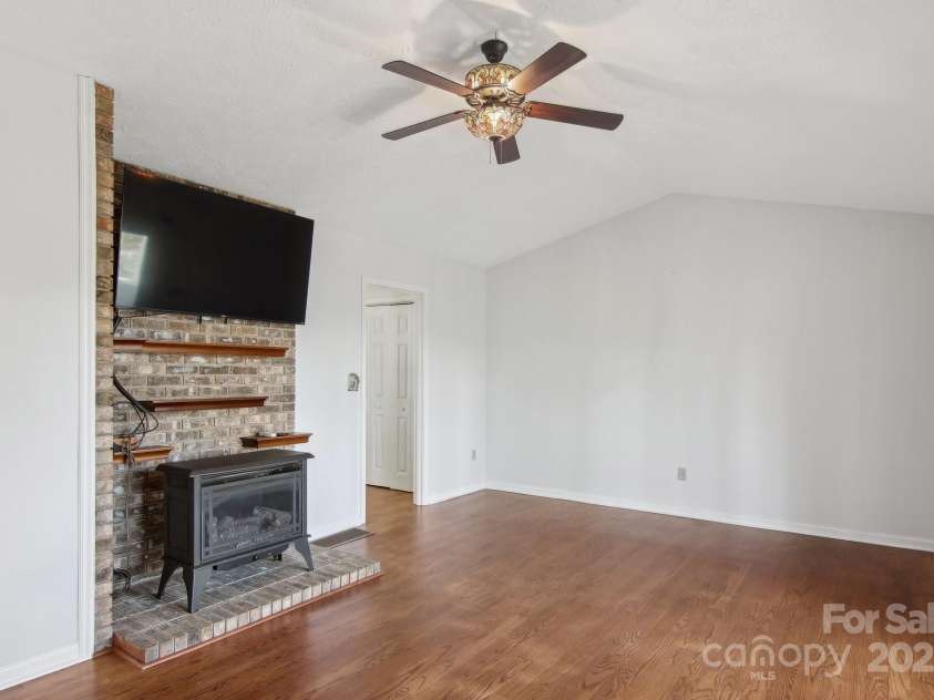 127 Kalmia Terrace Court, Hendersonville, NC 28739.  MLS# CAR4227852, YatesRealty ID 5821. Den with gas wood-stove and remote