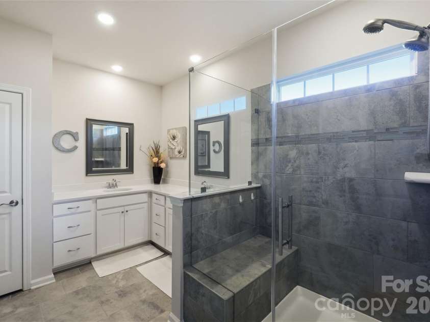 3162 Windhaven Lane, Tega Cay, SC 29708.  MLS# CAR4434420, YatesRealty ID 58210. Frameless shower enclosure with bench
