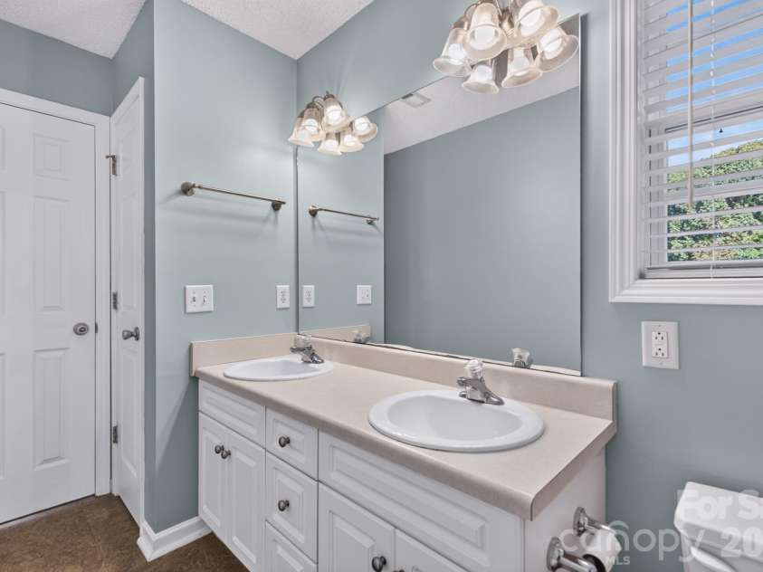 702 Painted Lady Court, Rock Hill, SC 29732.  MLS# CAR4433746, YatesRealty ID 58212. Pristine vanity area with ample counter space, full mirror, and modern lighting.