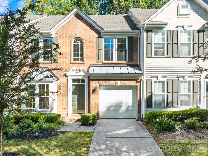 156 Arcadian Way, Mooresville, NC 28117.  MLS# CAR4434144, YatesRealty ID 58331. Brick front with a one-car garage