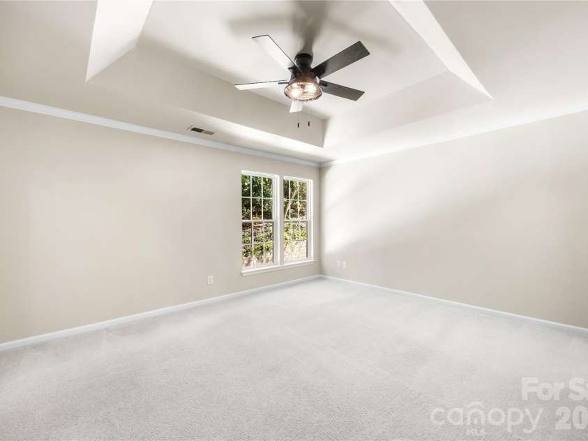 156 Arcadian Way, Mooresville, NC 28117.  MLS# CAR4434144, YatesRealty ID 58331. The primary bedroom features a tray ceiling and an updated ceiling fan