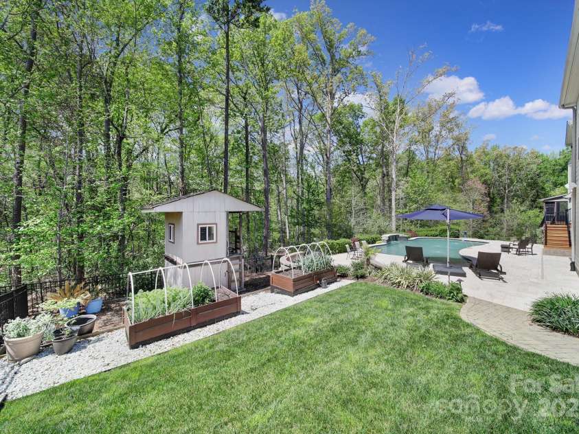 141 Forsythia Lane, Tega Cay, SC 29708.  MLS# CAR4243630, YatesRealty ID 5841. Backyard Gardens and Playhouse