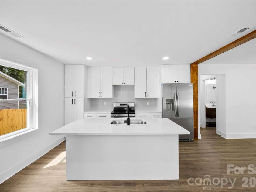 2942 Reid Avenue, Charlotte, NC 28208.  MLS# CAR4437077, YatesRealty ID 58487. Updated kitchen with stainless steel appliances.