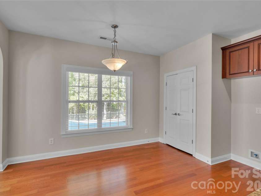 1240 Saint Johns Avenue, Matthews, NC 28104.  MLS# CAR4432333, YatesRealty ID 58630. Kitchen eating area overlooking backyard and pantry