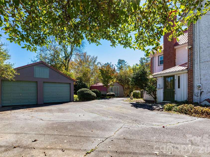 10 Best Life Lane, Brevard, NC 28712.  MLS# CAR4437749, YatesRealty ID 58772. Back of home & Garage