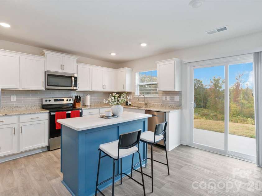 2147 Eastway Drive, Dallas, NC 28034.  MLS# CAR4313585, YatesRealty ID 5895. Kitchen with opening to the backyard