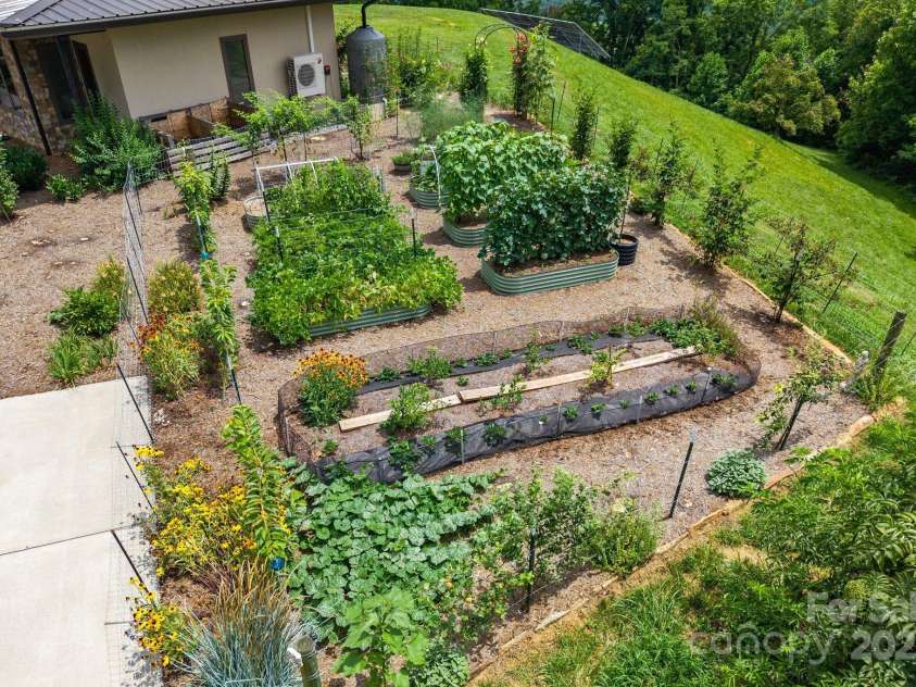 1045 & 1047 Graham Road, Marshall, NC 28753.  MLS# CAR4280943, YatesRealty ID 59. So much food is produced from this beautiful garden