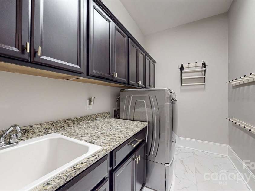 819 Beauhaven Lane, Waxhaw, NC 28173.  MLS# CAR4242522, YatesRealty ID 5915. Laundry Room w/Sink & Storage Cabinets