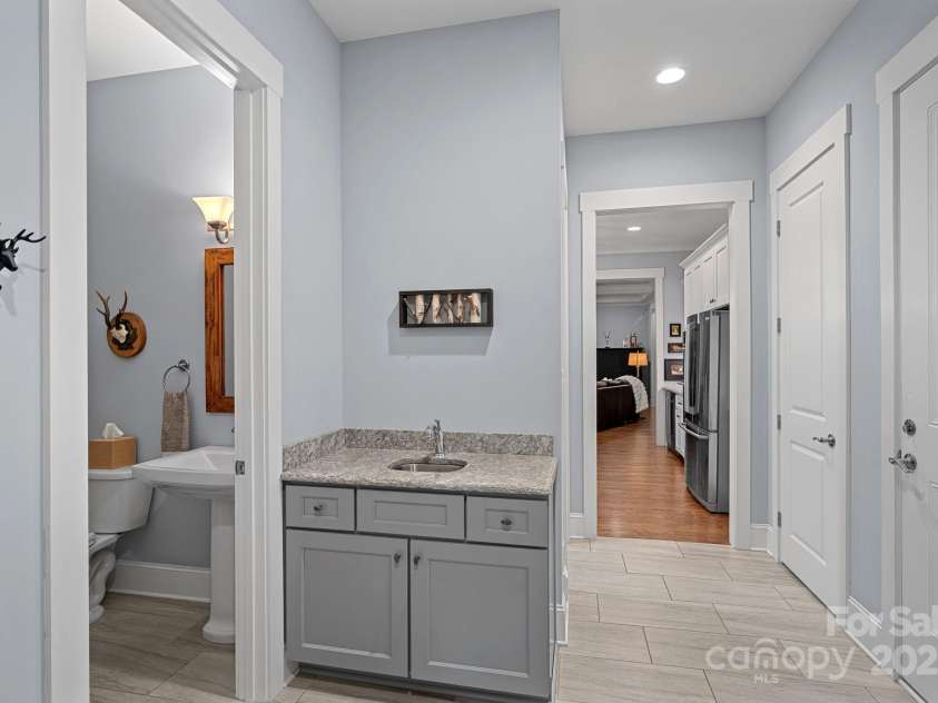 4637 Gold Finch Drive, Denver, NC 28037.  MLS# CAR4243866, YatesRealty ID 5930. Mudroom even has a sink with a granite countertop. Half bath off of the mud room area.