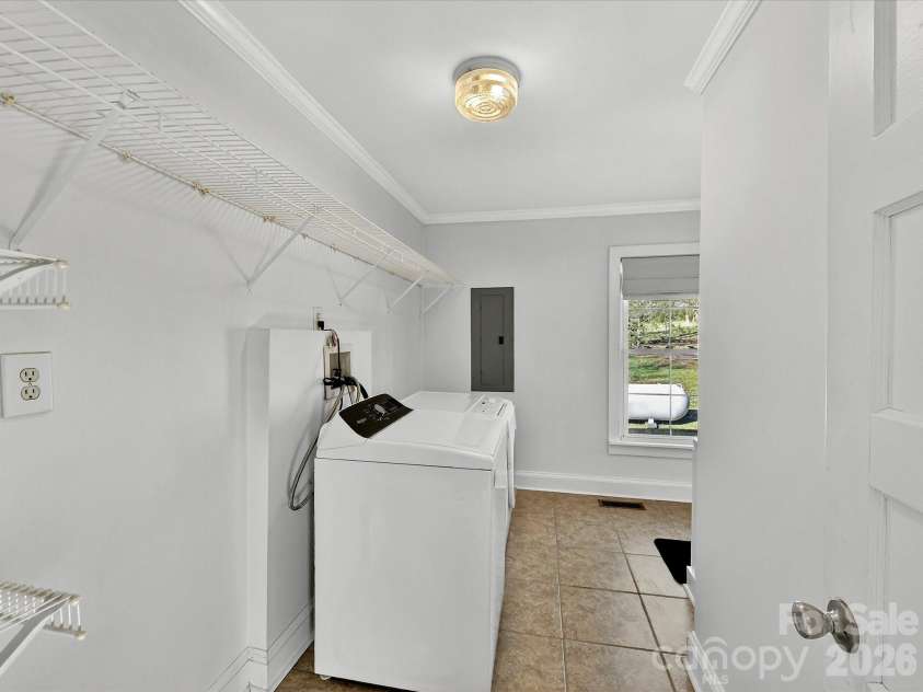 6590 Camp Creek Road, Lancaster, SC 29720.  MLS# CAR4359392, YatesRealty ID 5933. Oversized Laundry Room with Storage Shelves