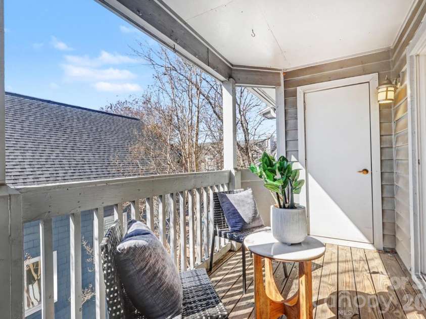 525 Graham Street, Charlotte, NC 28202.  MLS# CAR4341824, YatesRealty ID 5934. Covered balcony offering quiet outdoor space in the heart of Uptown - looking down to a view of the pool from above.