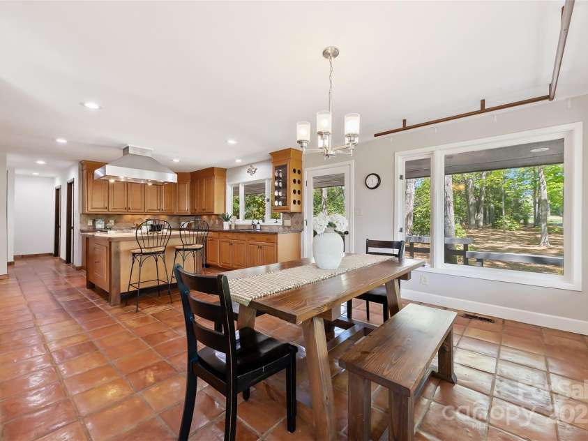 21 Hollyberry Woods, Lake Wylie, SC 29710.  MLS# CAR4241992, YatesRealty ID 5963. Spacious dining area leads to expansive wrap around deck with built in gas grill connection.