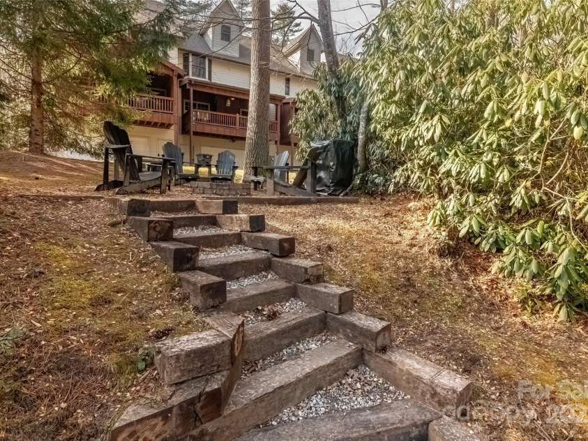 620 Sapphire Valley Road, Cashiers, NC 28717.  MLS# CAR4329121, YatesRealty ID 598. Above the chairs you see the covered wooden deck on the rear of Unit 