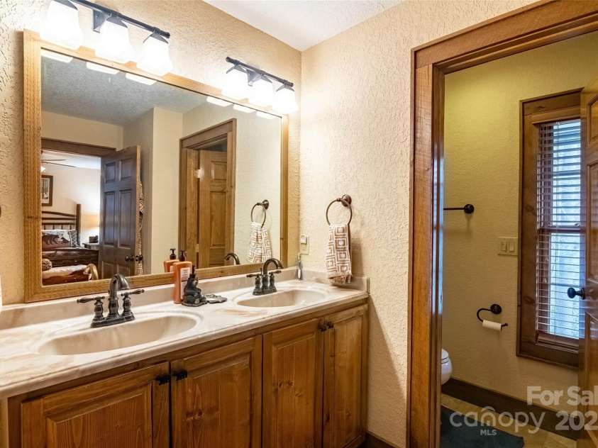 620 Sapphire Valley Road, Cashiers, NC 28717.  MLS# CAR4329121, YatesRealty ID 598. En-Suite #1 Bathroom with double sink vanity.