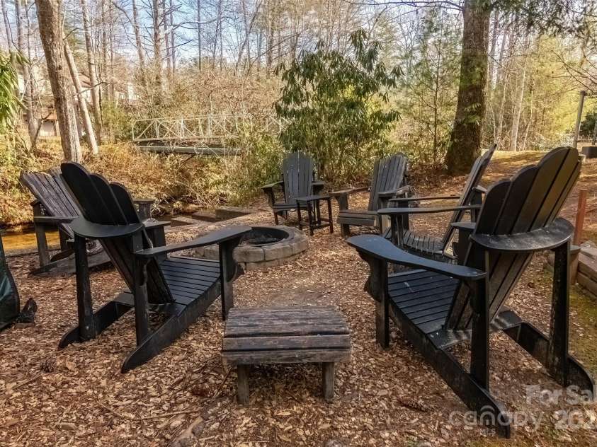 620 Sapphire Valley Road, Cashiers, NC 28717.  MLS# CAR4329121, YatesRealty ID 598. The firepit and these chairs sit right next to the Horsepasture River! Fish, wade, play in the water!