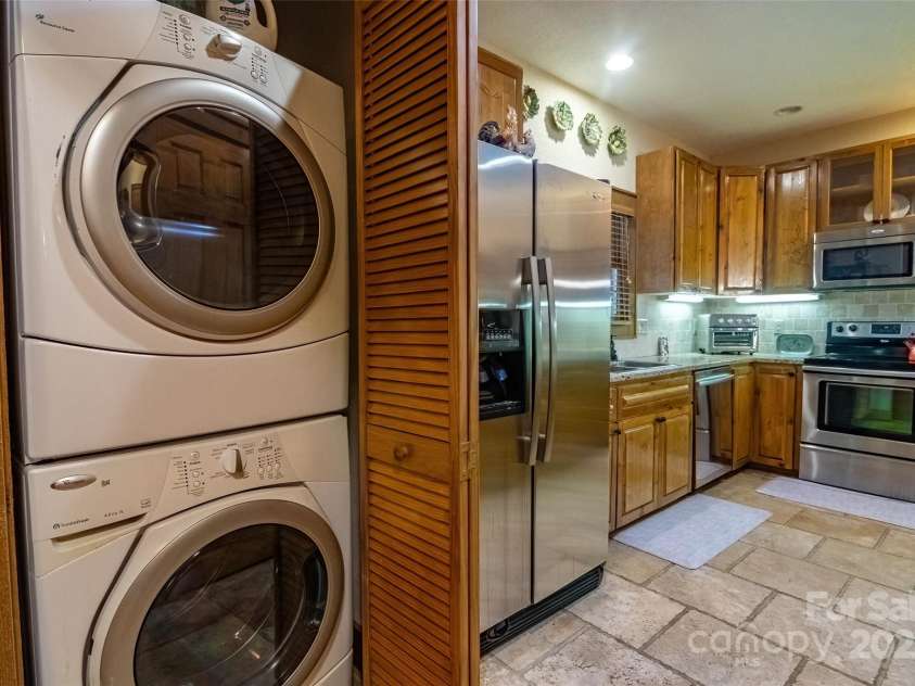 620 Sapphire Valley Road, Cashiers, NC 28717.  MLS# CAR4329121, YatesRealty ID 598. The laundry closet is conveniently located next to the kitchen. The kitchen has a stylish ceramic tile floor.